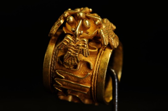 Gold ring with zodiac and bird design